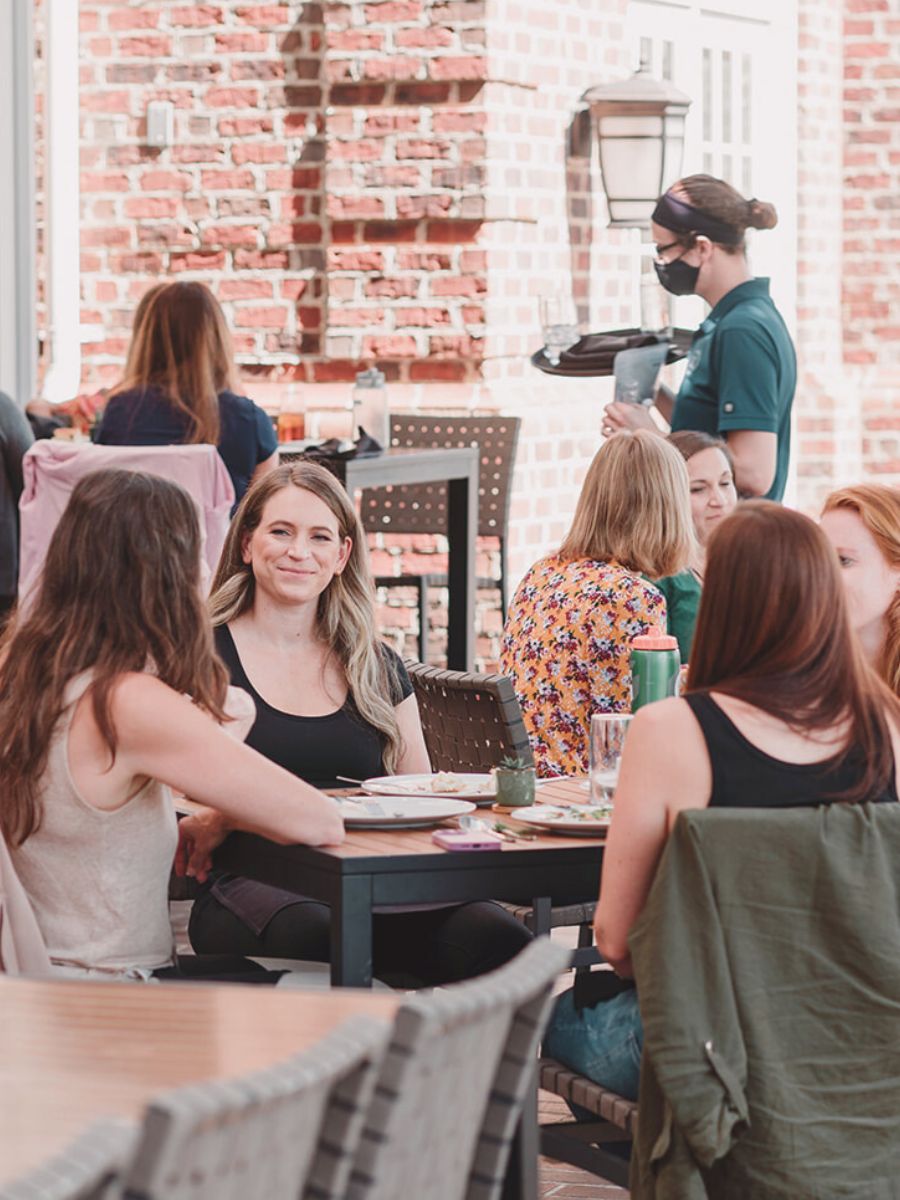 Business Coach Laura Schoenfeld socializing and having client conversations