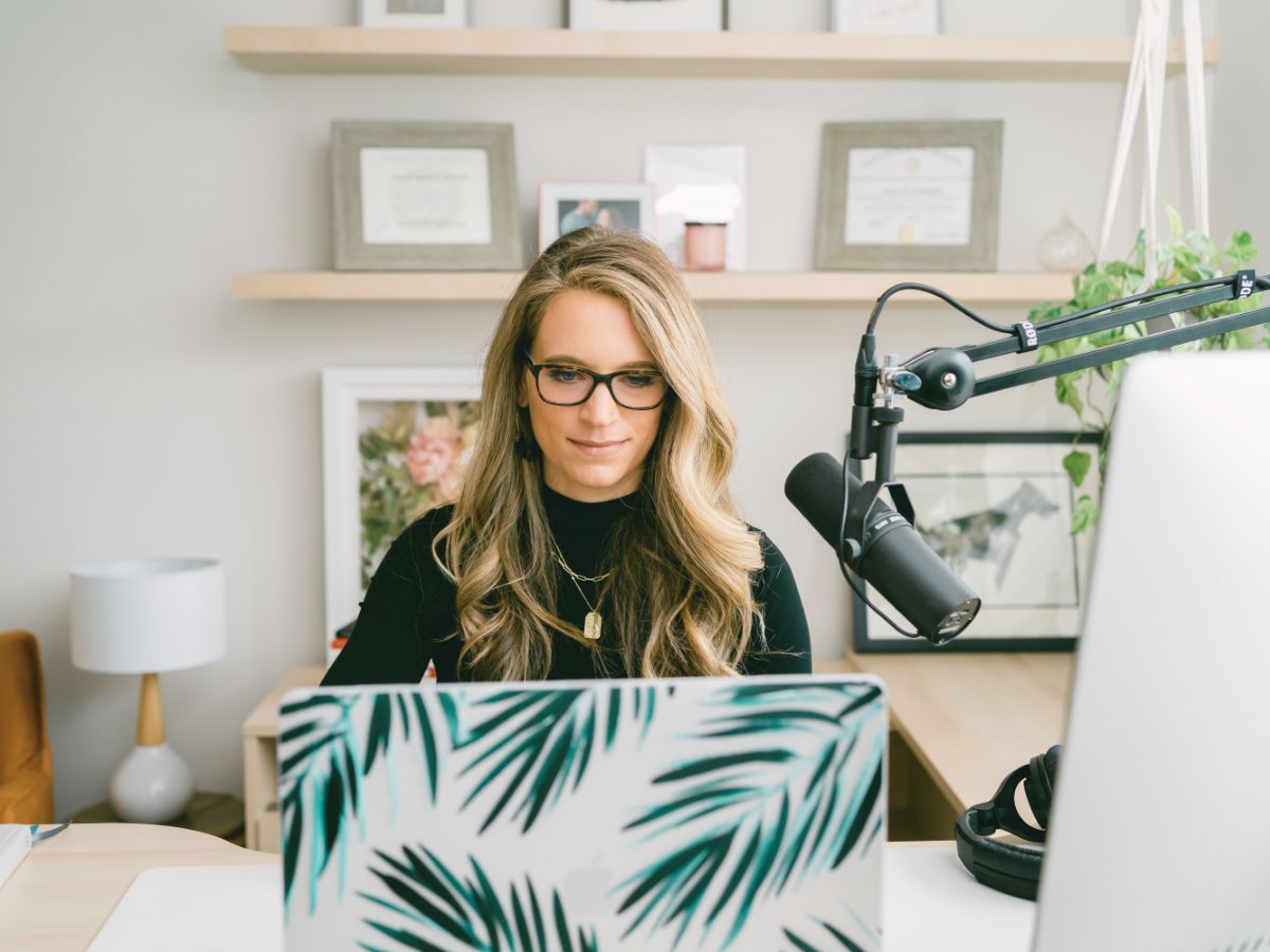 Business Coach Laura Schoenfeld in front of laptop photo used in blog about how to grow your email list (with the right people) as a health expert