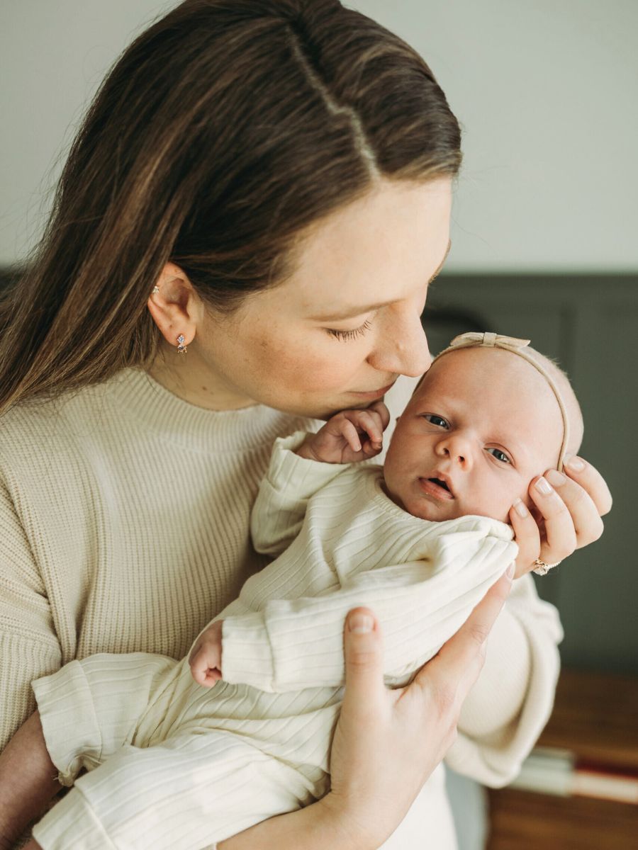 Business Coach and Mom Laura Schoenfeld holding baby Mabel blog about going from one to two kids as a business owner